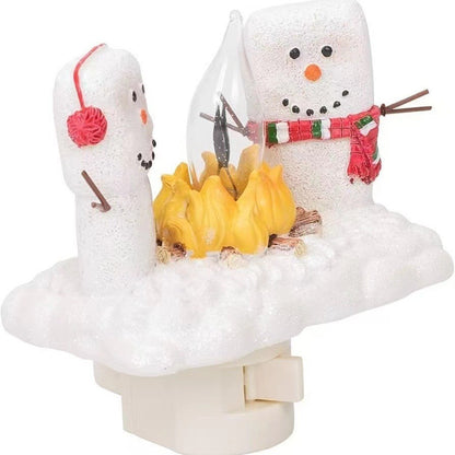 Decorative night light shaped like a snowman with a small tree and colorful scarf on a white background.
